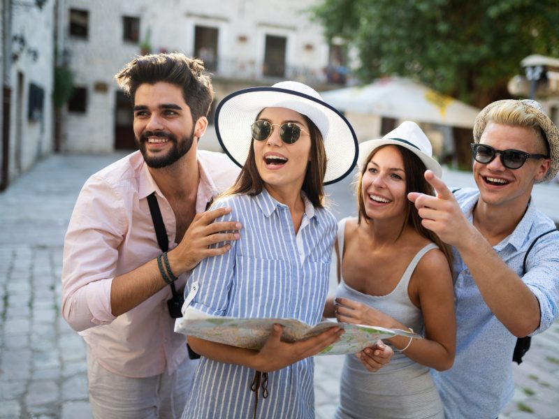 Happy group of tourists traveling and sightseeing together