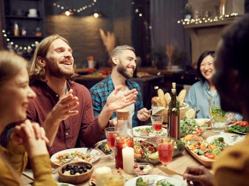 People Laughing at Dinner Table