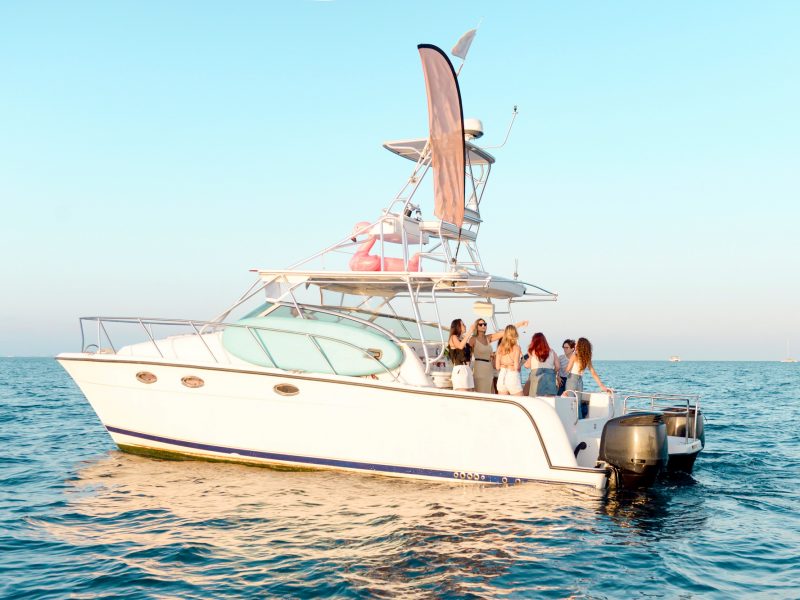 Youth party on vacation at sea. Girlfriends drink champagne, dance on the yacht